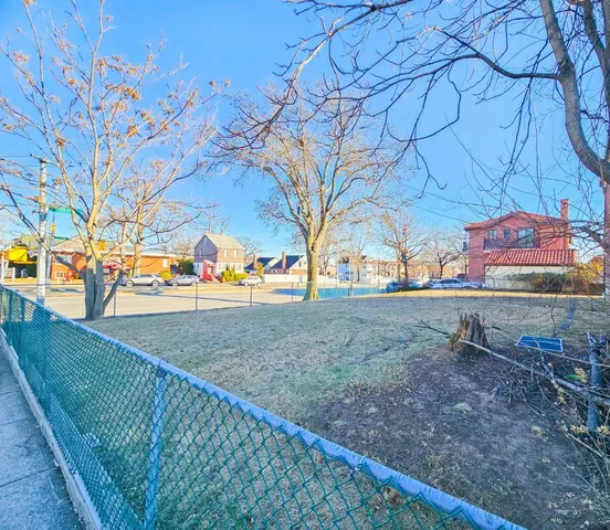 a view of outdoor space with lots of swings and slides