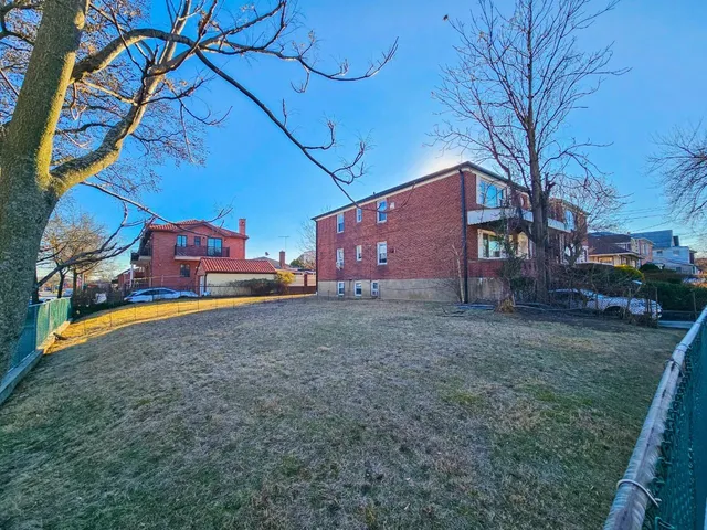 a backyard of a house with oven and wooden fence