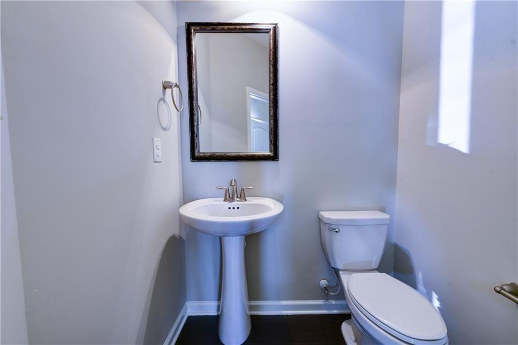 1226 Fischer Trace Cumming, GA 30041 - Photo 11 of 24 a bathroom with a toilet sink and mirror