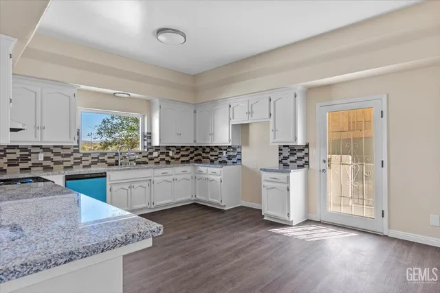 a kitchen with wooden floors and white appliances