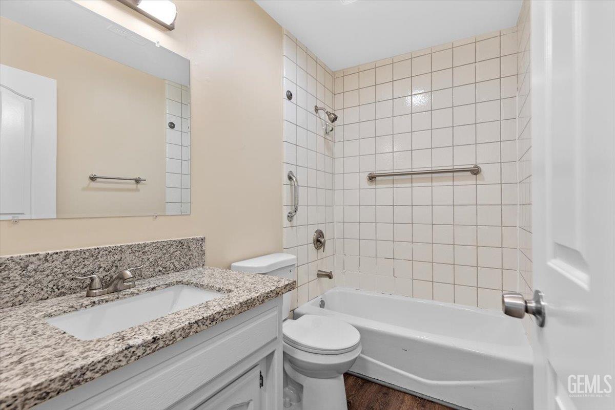 Undisclosed Address Tehachapi, CA 93561 - Photo 18 of 40 a bathroom with a granite countertop sink toilet and shower