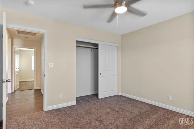 a view of a livingroom with a chandelier fan