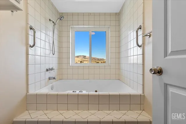 a bathroom with a bathtub and a shower