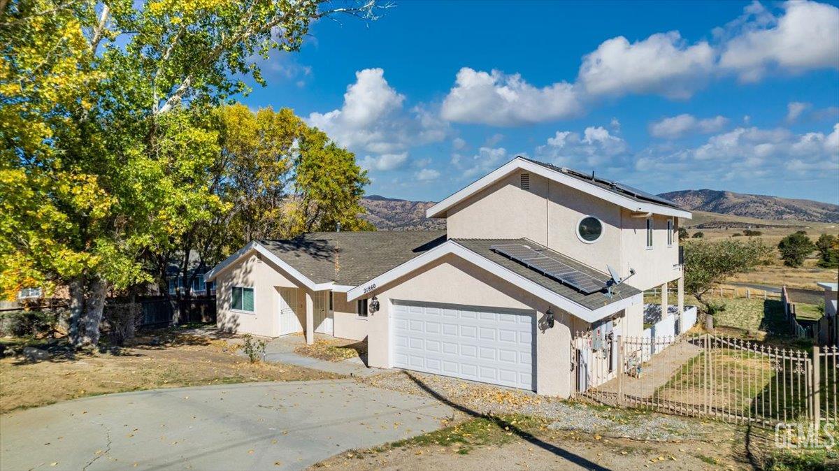 Undisclosed Address Tehachapi, CA 93561 - Photo 28 of 40 a view of a white house next to a road and yard