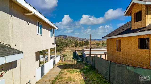 a view of a patio with couches under an umbrella