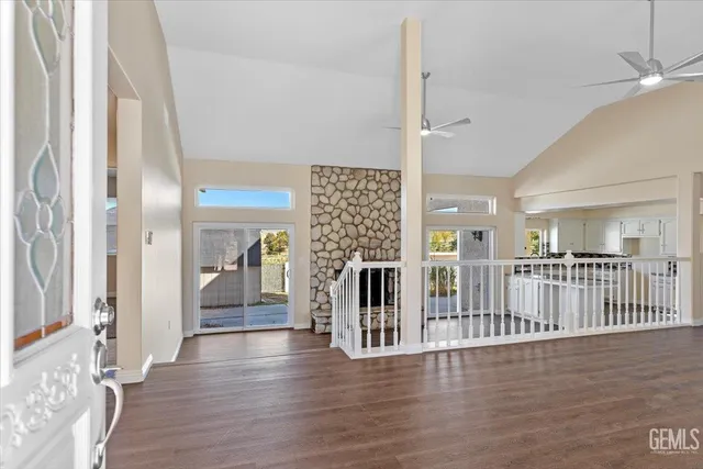 a view of a hallway with wooden floor and entryway