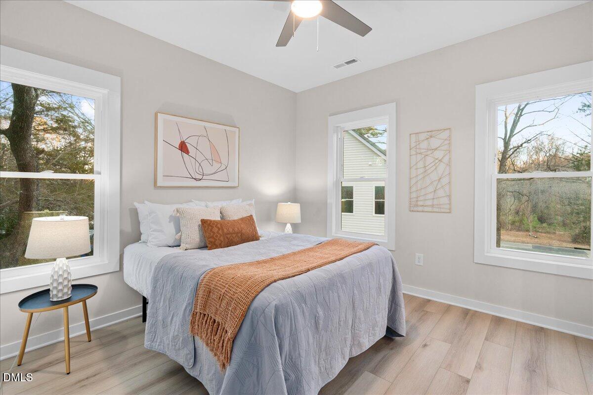 1917 Essex Road, Unit A Durham, NC 27704 - Photo 20 of 26 a bedroom with a bed and wooden floor
