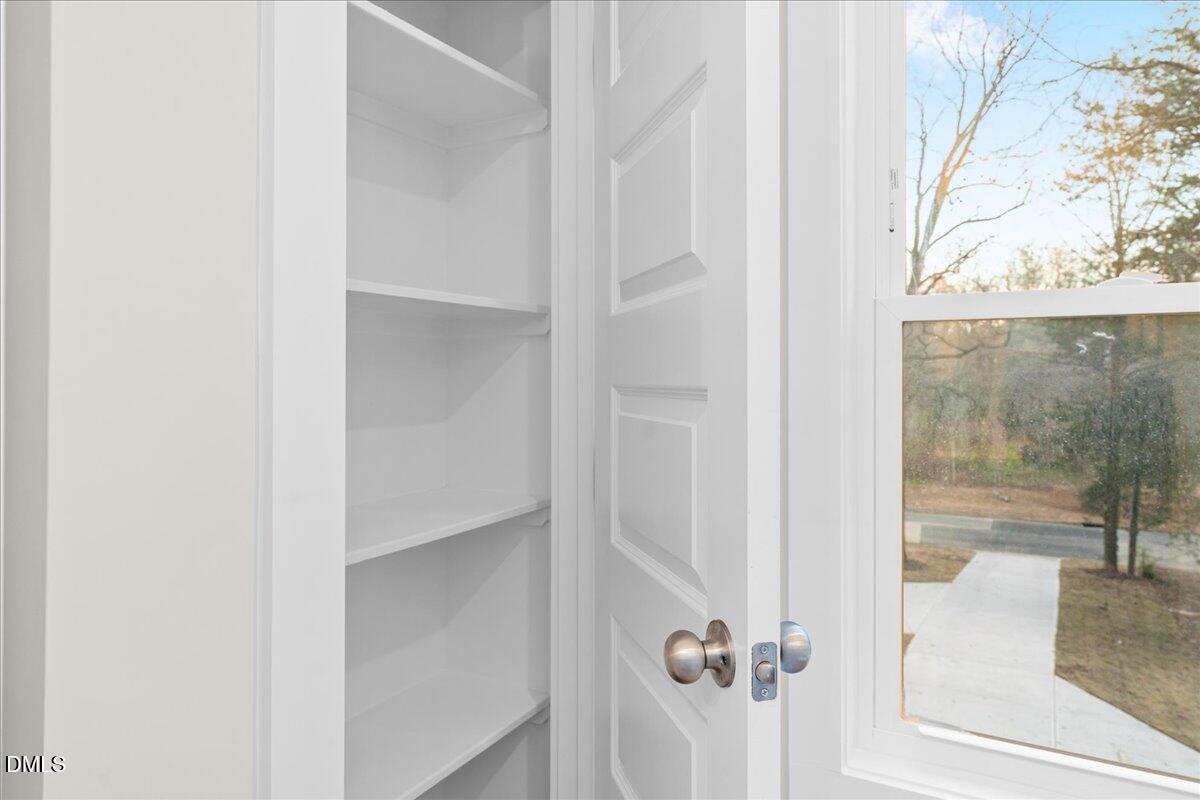1917 Essex Road, Unit A Durham, NC 27704 - Photo 24 of 26 a bathroom with a glass shower door
