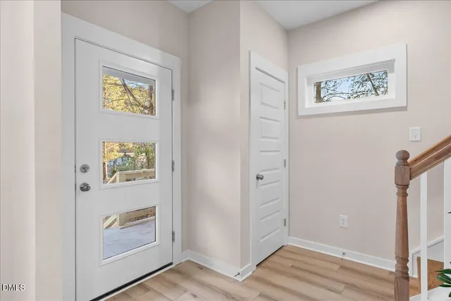 a view of an entryway with wooden floor