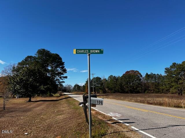 147 Charles Brown Road Warrenton, NC 27589 - Photo 17 of 18 a street sign on a sidewalk next to a road