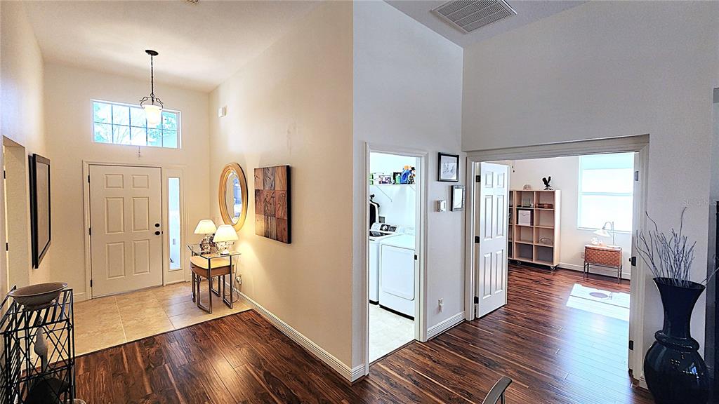 1636 West Caroline Path Lecanto, FL 34461 - Photo 24 of 85 a view of a hallway with wooden floor and furniture