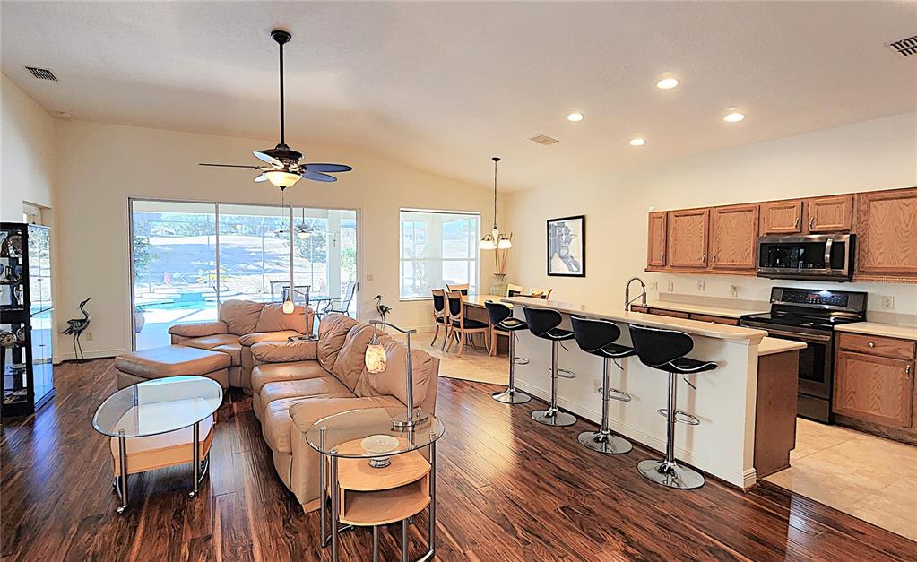 1636 West Caroline Path Lecanto, FL 34461 - Photo 37 of 85 a living room with furniture kitchen and a wooden floor