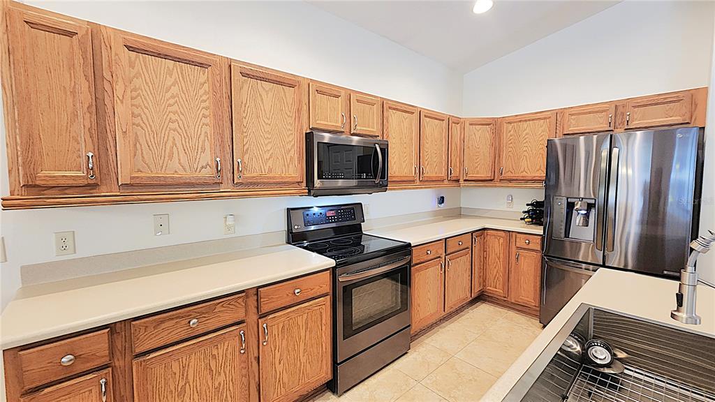 1636 West Caroline Path Lecanto, FL 34461 - Photo 40 of 85 a kitchen with stainless steel appliances granite countertop a refrigerator stove top oven and sink