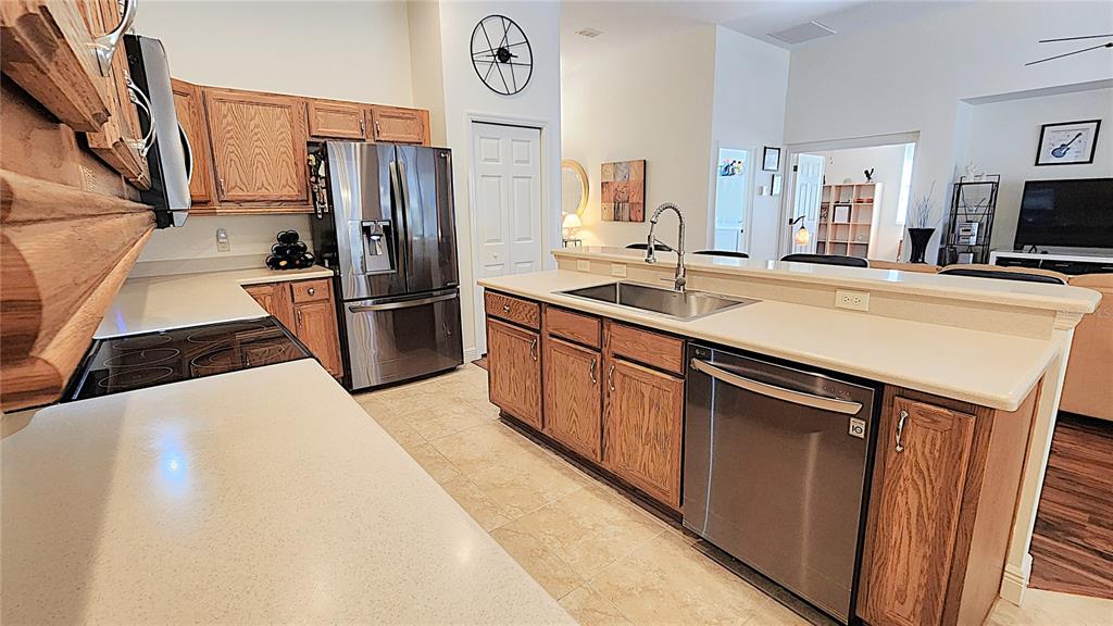 1636 West Caroline Path Lecanto, FL 34461 - Photo 42 of 85 a kitchen with stainless steel appliances a refrigerator a sink a stove and cabinets