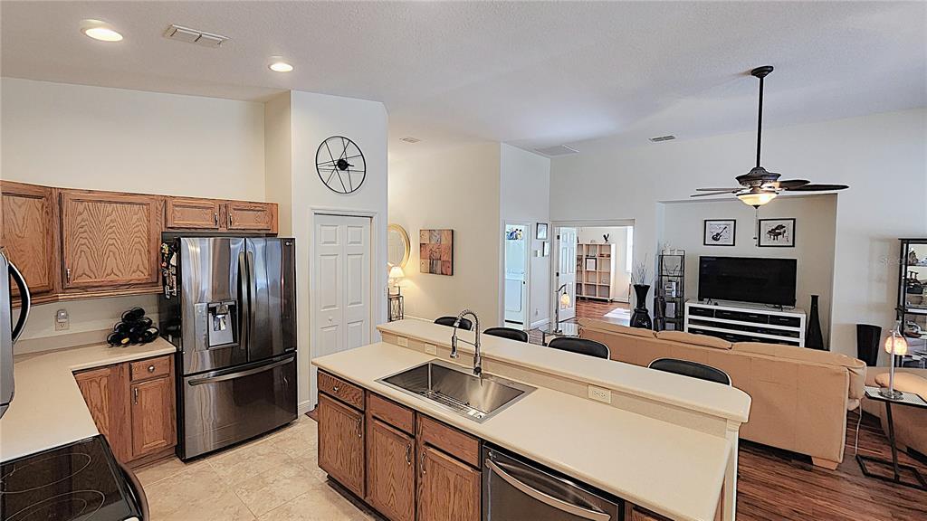 1636 West Caroline Path Lecanto, FL 34461 - Photo 43 of 85 a kitchen with stainless steel appliances a refrigerator a sink a stove and a center island