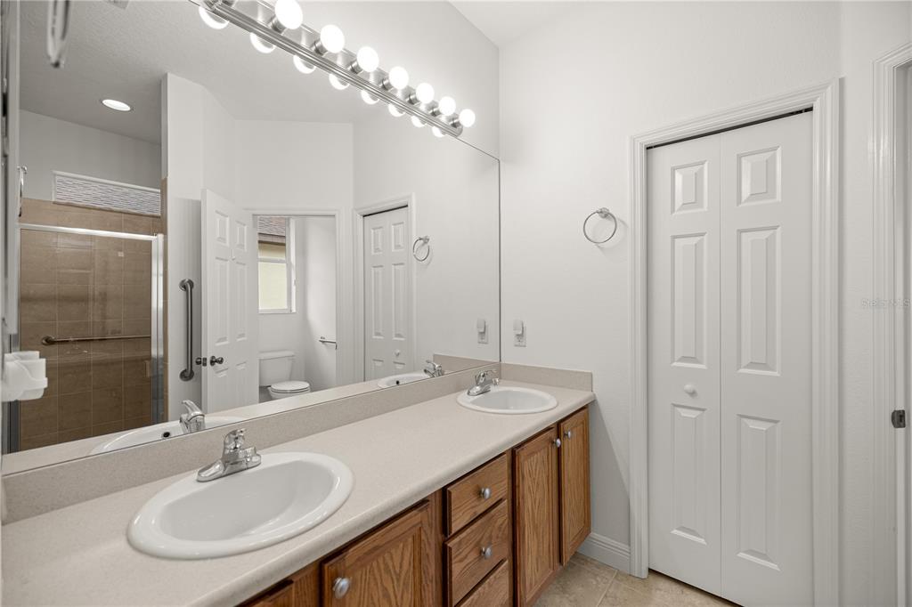 1636 West Caroline Path Lecanto, FL 34461 - Photo 55 of 85 a bathroom with a sink double vanity and a mirror