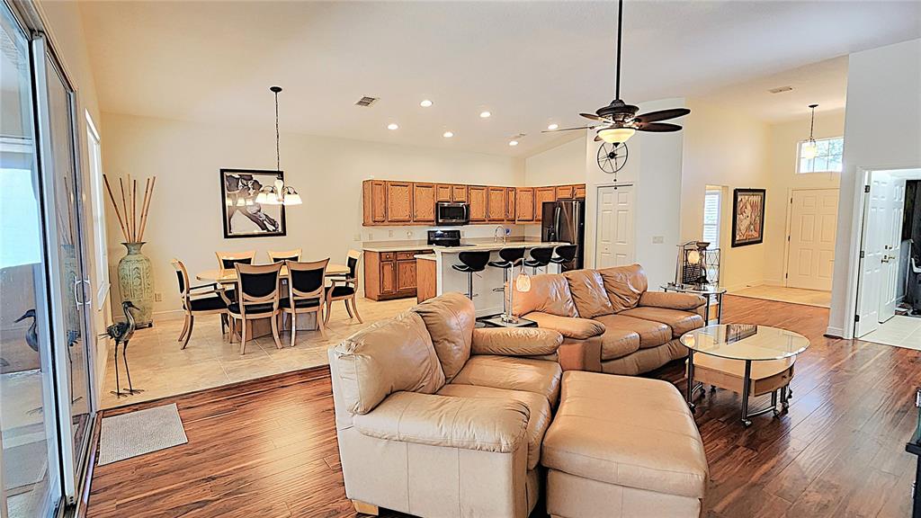 1636 West Caroline Path Lecanto, FL 34461 - Photo 64 of 85 a living room with furniture a flat screen tv and kitchen view