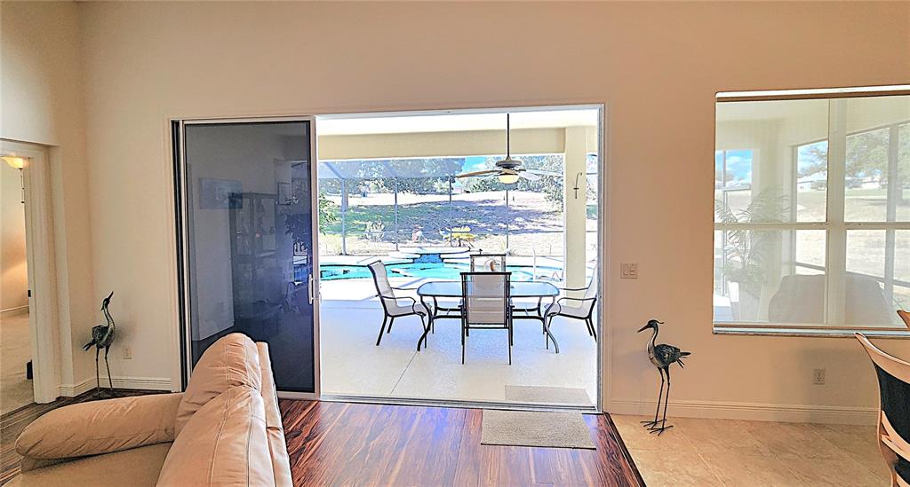 1636 West Caroline Path Lecanto, FL 34461 - Photo 66 of 85 a dining room with furniture a chandelier and wooden floor