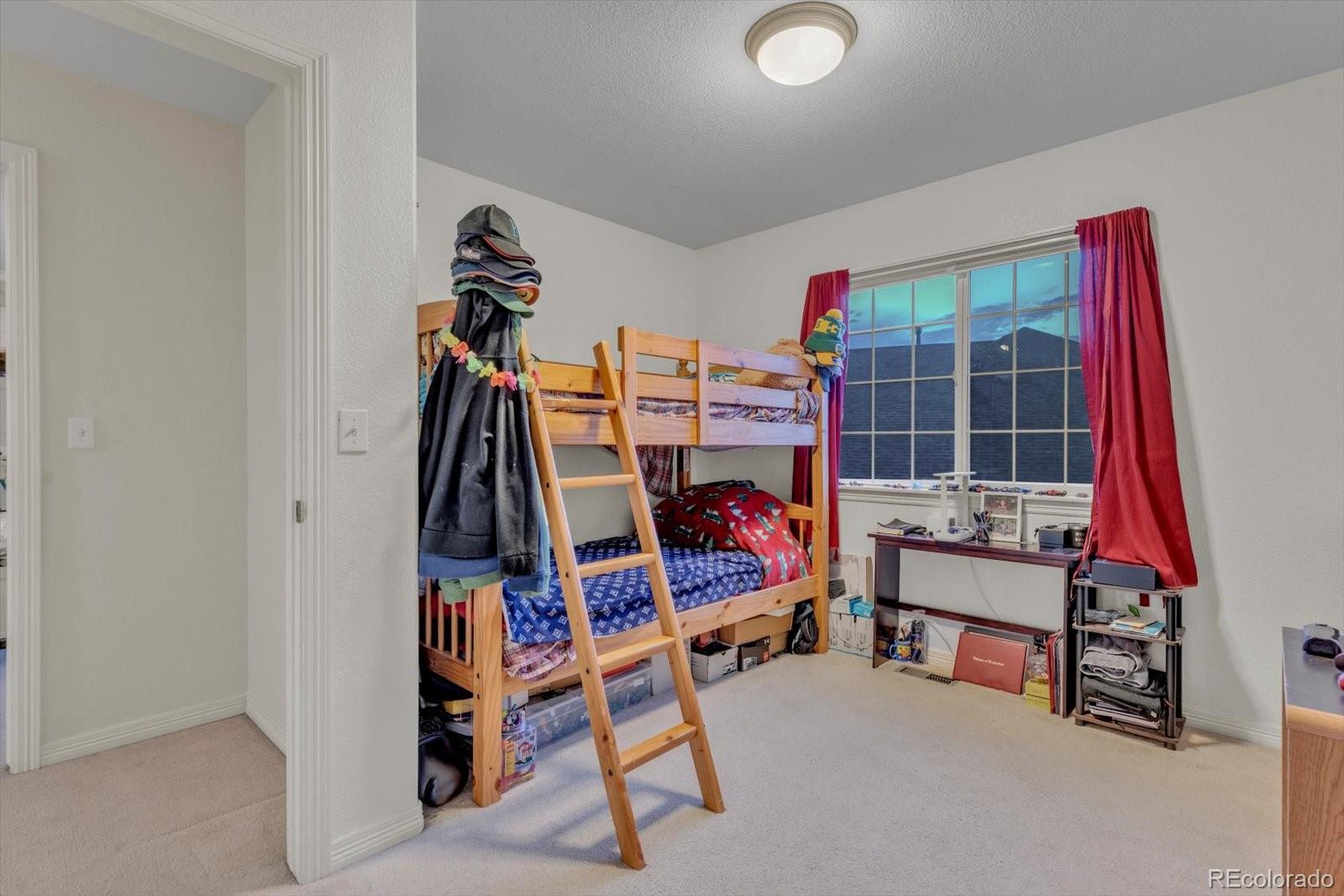 4786 Rabbit Mountain Road Broomfield, CO 80020 - Photo 24 of 41 a bedroom with furniture and a window