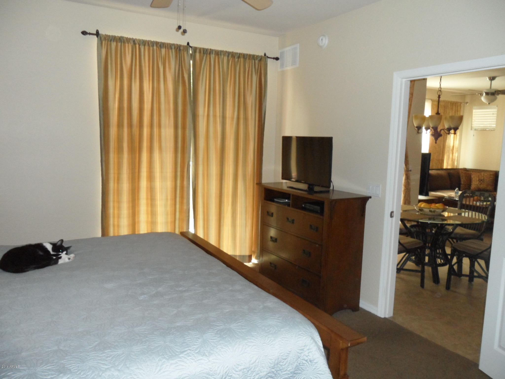 3330 South Gilbert Road, Unit 1015 Chandler, AZ 85286 - Photo 11 of 30 a bedroom with a bed and wooden floor