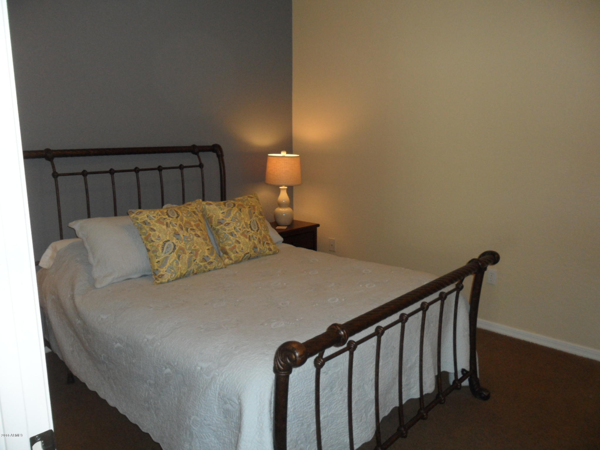 3330 South Gilbert Road, Unit 1015 Chandler, AZ 85286 - Photo 13 of 30 a bedroom with a bed and a lamp