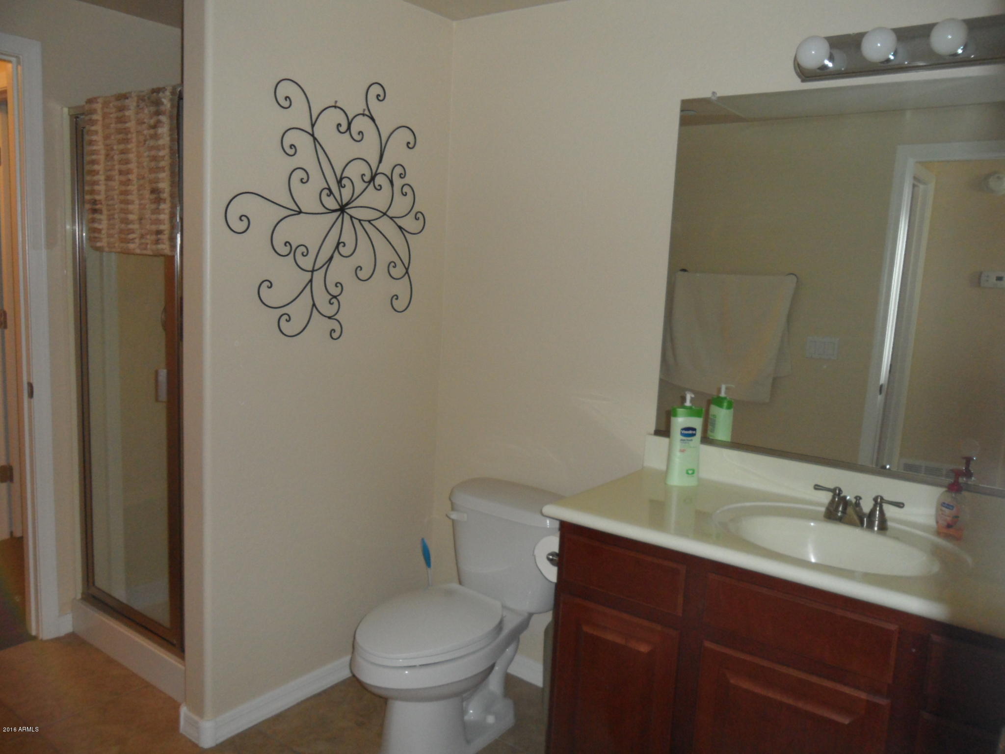 3330 South Gilbert Road, Unit 1015 Chandler, AZ 85286 - Photo 17 of 30 a bathroom with a toilet sink and mirror
