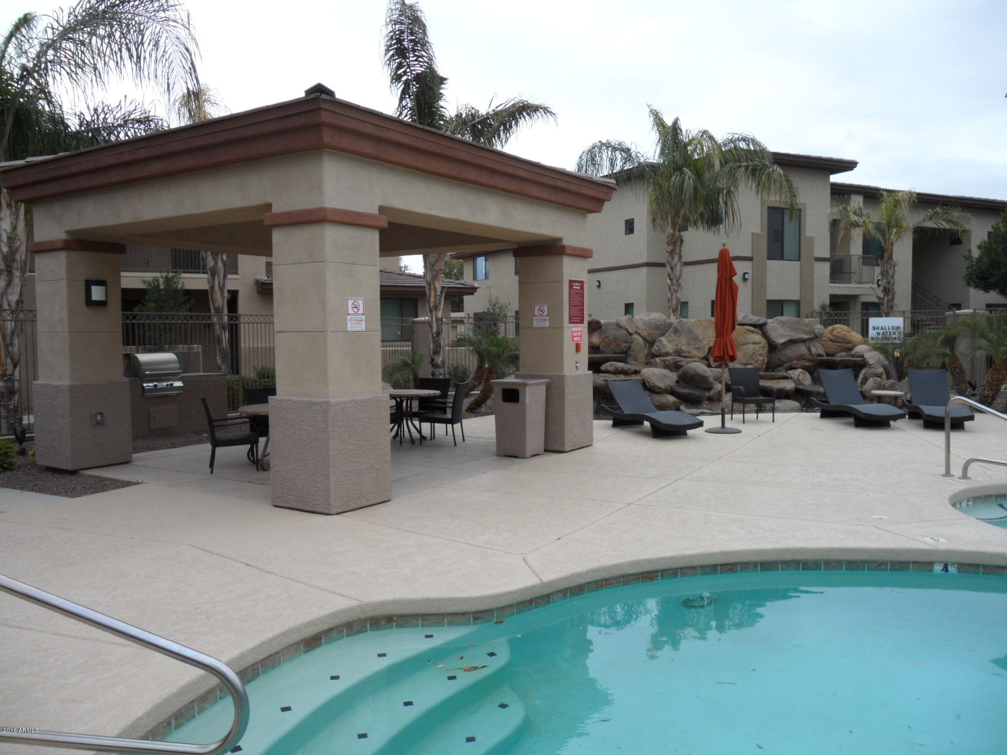 3330 South Gilbert Road, Unit 1015 Chandler, AZ 85286 - Photo 23 of 30 a backyard of a house with yard and outdoor seating