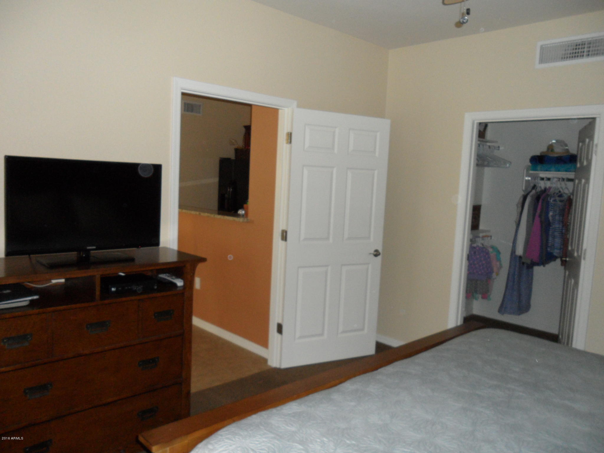 3330 South Gilbert Road, Unit 1015 Chandler, AZ 85286 - Photo 8 of 30 a room with furniture and a flat screen tv