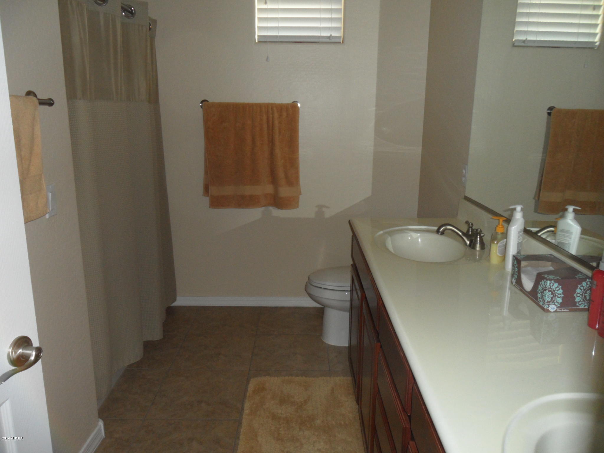 3330 South Gilbert Road, Unit 1015 Chandler, AZ 85286 - Photo 10 of 30 a bathroom with a sink toilet and a mirror