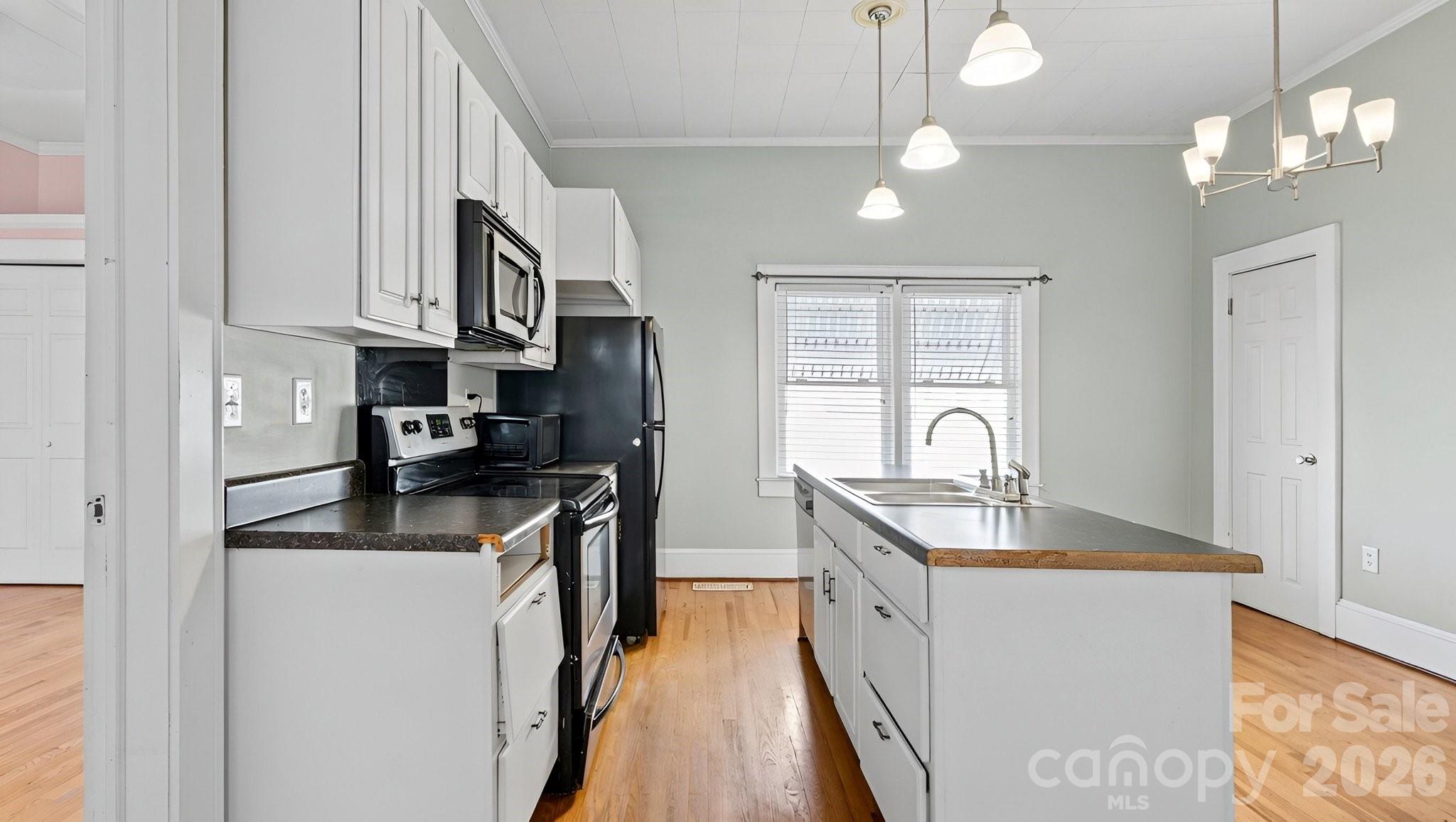 901 Mill Street Albemarle, NC 28001 - Photo 13 of 27 a kitchen with stainless steel appliances granite countertop a sink stove and refrigerator