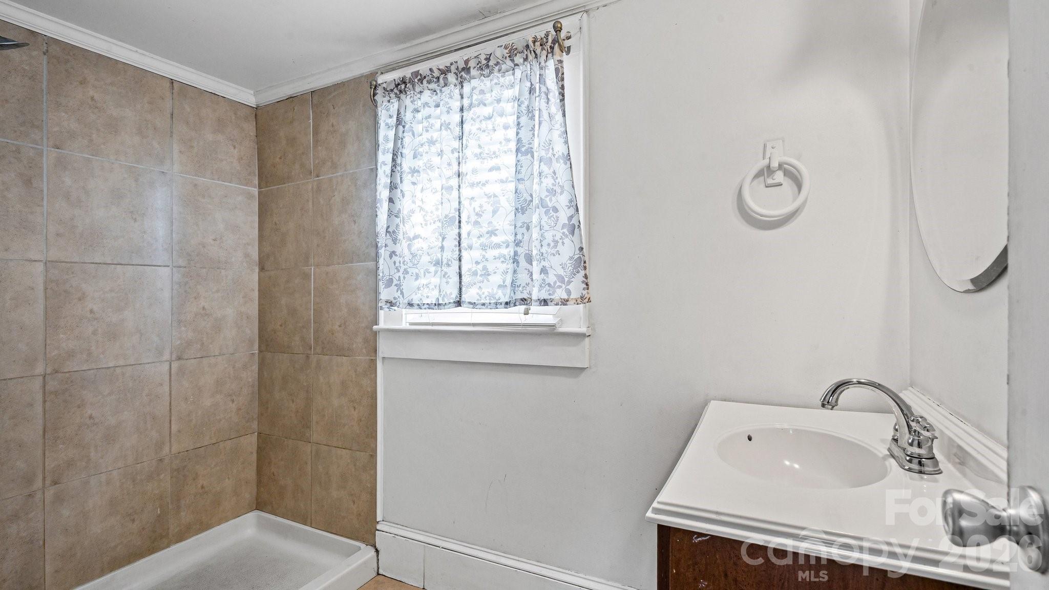 901 Mill Street Albemarle, NC 28001 - Photo 14 of 27 a bathroom with a sink toilet and shower