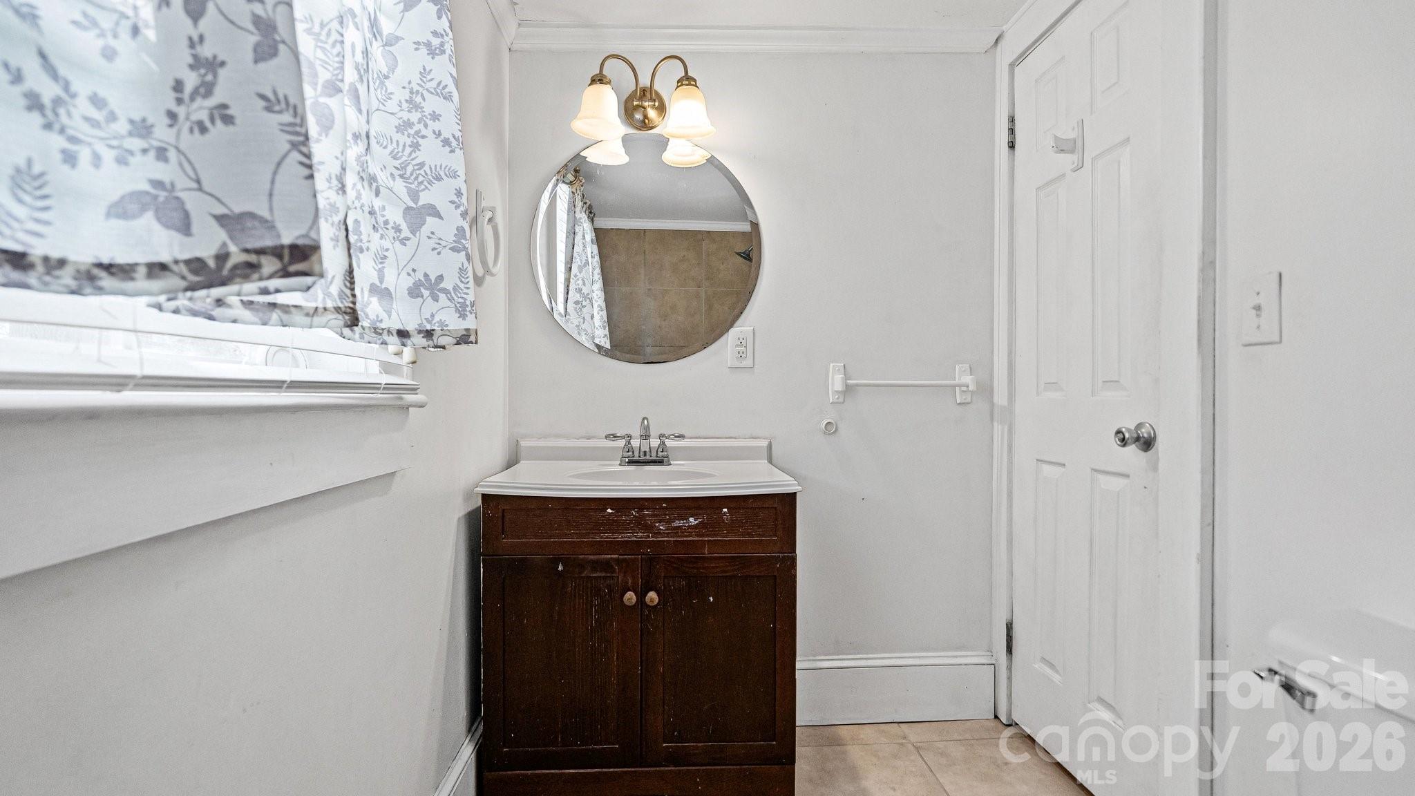 901 Mill Street Albemarle, NC 28001 - Photo 15 of 27 a bathroom with a sink and a mirror