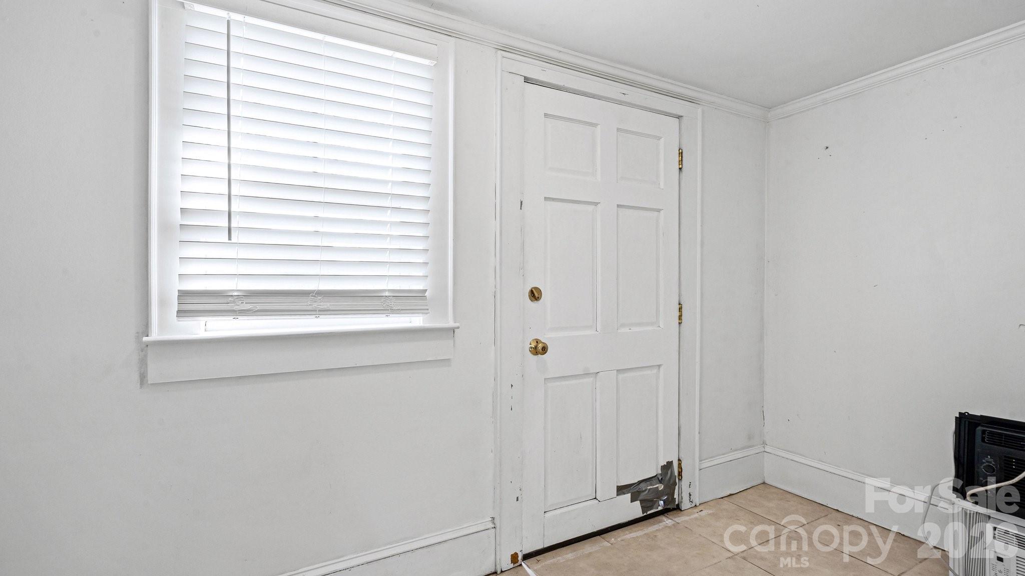 901 Mill Street Albemarle, NC 28001 - Photo 18 of 27 a view of a bedroom with a window and a bathroom