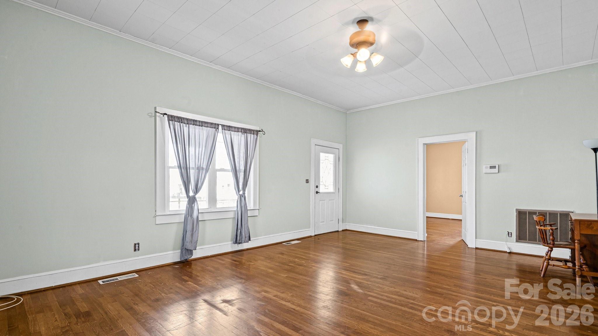 901 Mill Street Albemarle, NC 28001 - Photo 8 of 27 wooden floor in an empty room with a window