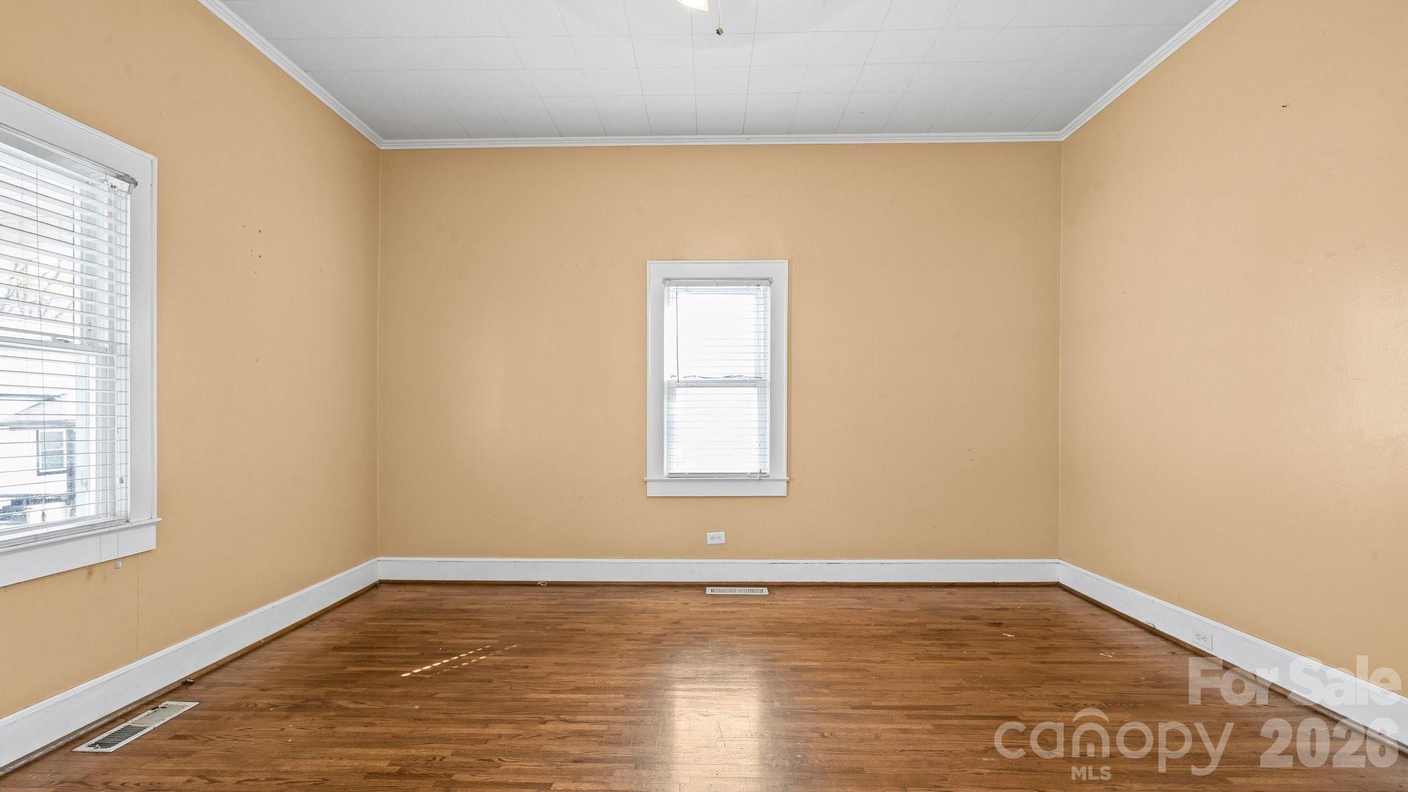 901 Mill Street Albemarle, NC 28001 - Photo 9 of 27 a view of an empty room with wooden floor and a window