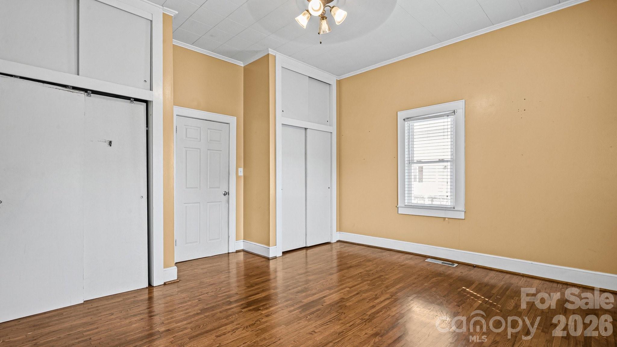 901 Mill Street Albemarle, NC 28001 - Photo 10 of 27 wooden floor in an empty room with a window