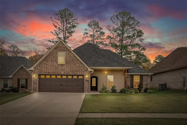 a front view of a house with a garden
