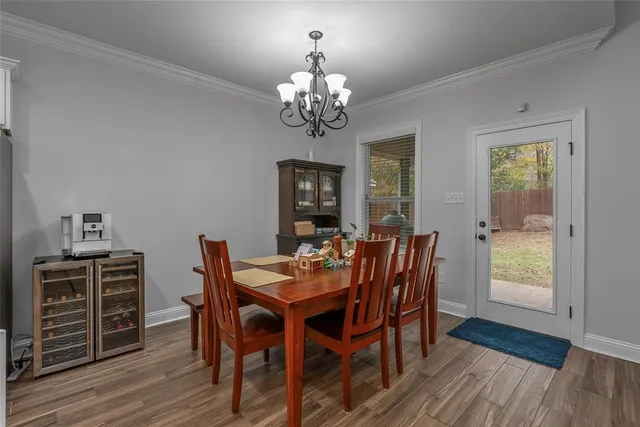 a kitchen with kitchen island a appliances dining table and chairs