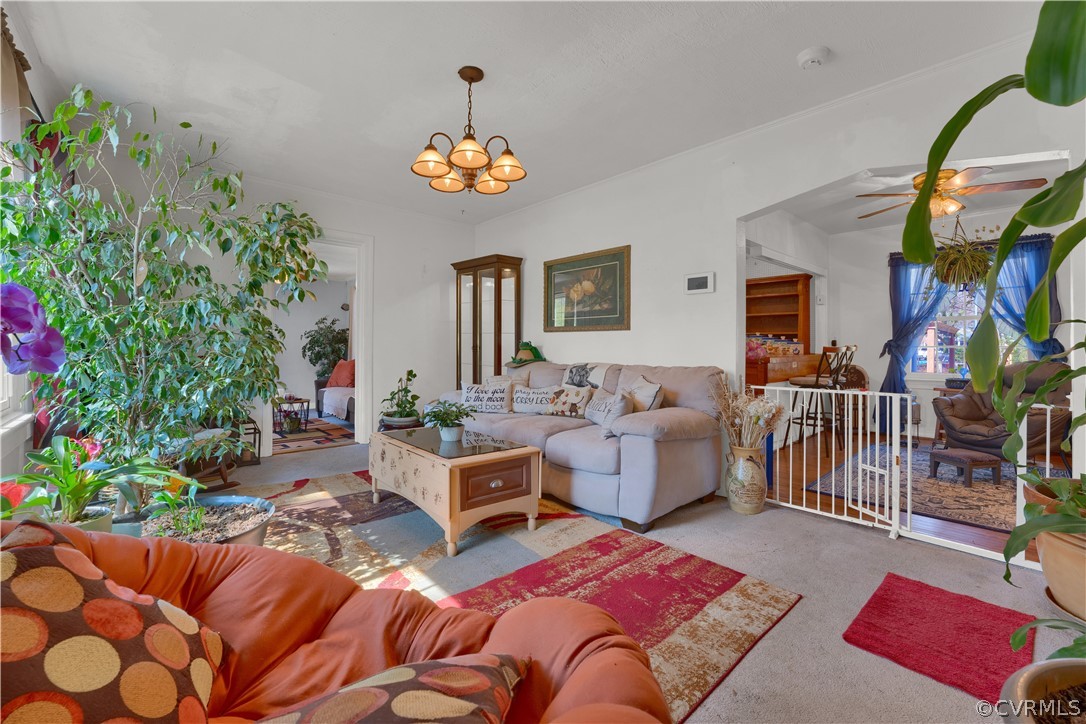 5218 Jahnke Road Richmond, VA 23225 - Photo 18 of 35 a living room with furniture and a chandelier