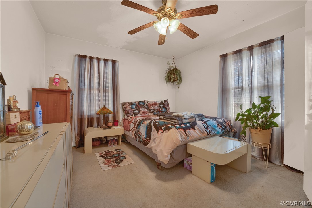 5218 Jahnke Road Richmond, VA 23225 - Photo 34 of 35 a spacious bedroom with a bed and a chandelier