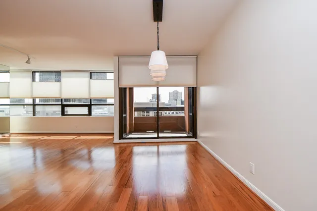 a view of a room with wooden floor