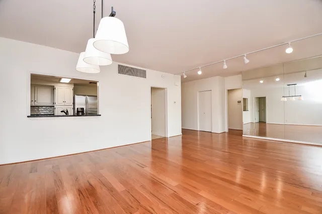 a view of a kitchen with a sink and a refrigerator