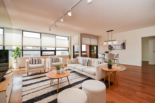 a living room with furniture and wooden floor