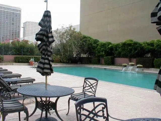a view of swimming pool with outdoor seating and plants