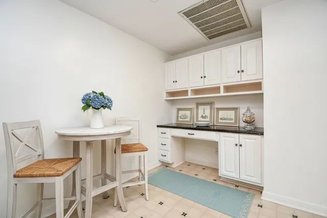 a kitchen with a sink cabinets and chair