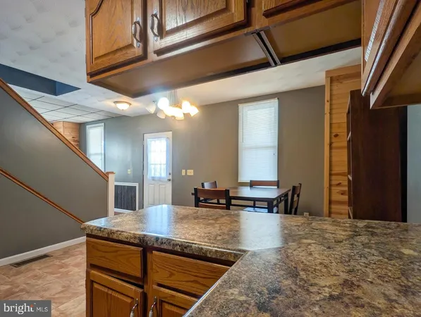 a view of kitchen with granite countertop window
