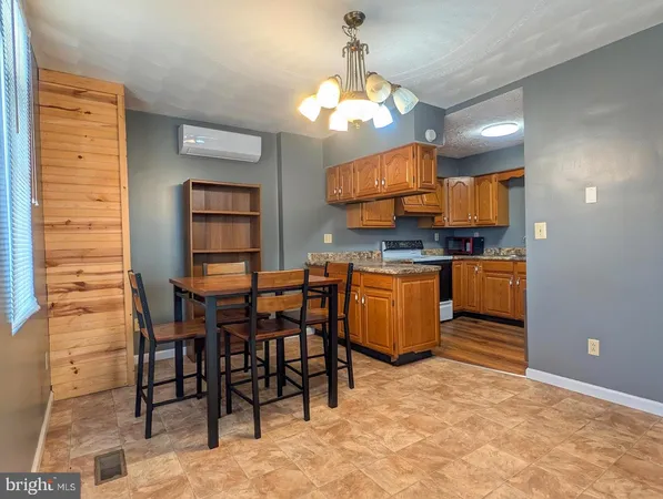 a kitchen with stainless steel appliances kitchen island granite countertop a stove a sink and a refrigerator