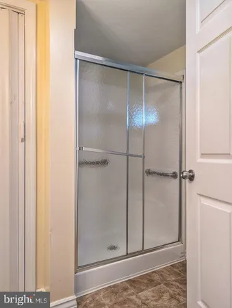 a bathroom with a glass shower door