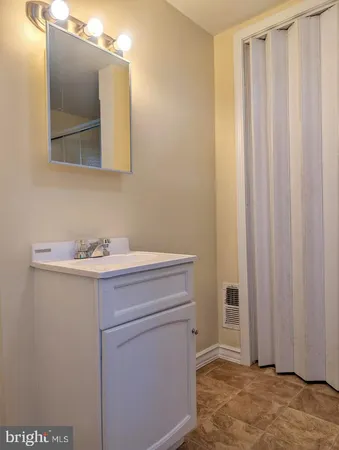 a bathroom with a sink a toilet and a mirror
