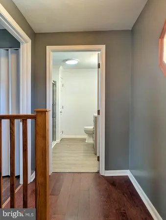 a view of a room with wooden floor